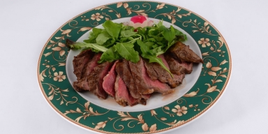 Beef steak tagliata style with rocket salad